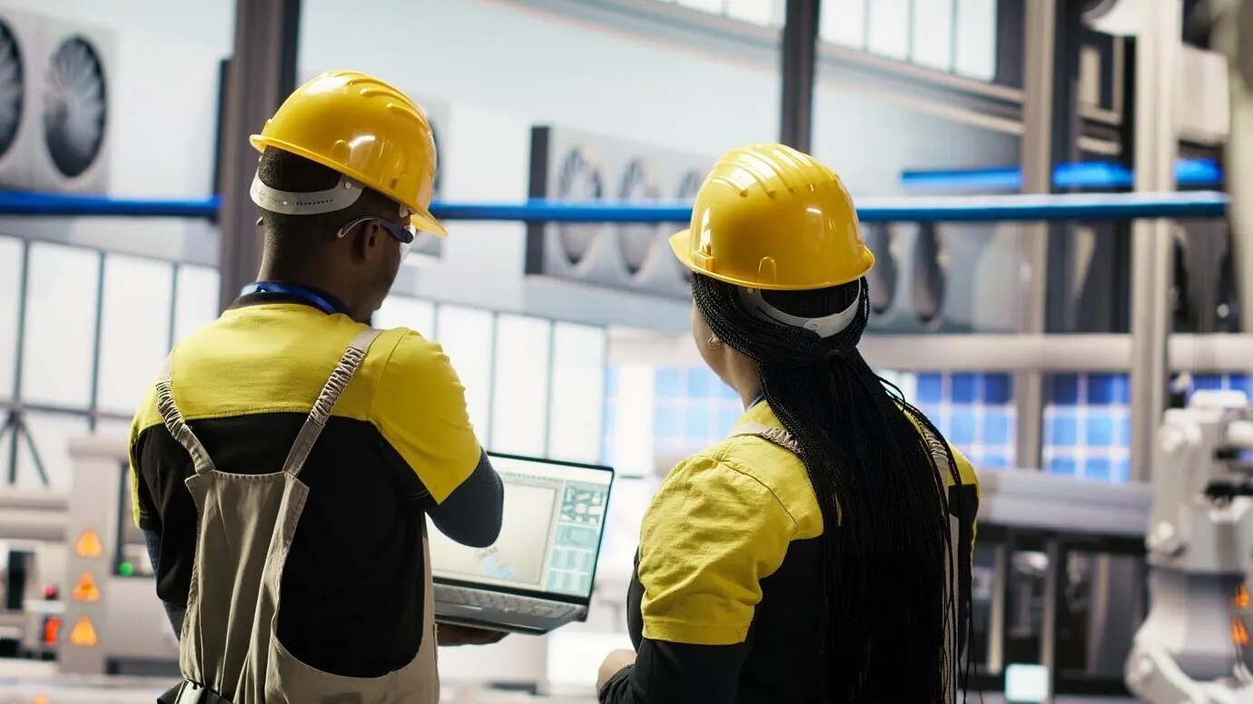 Ein Ingenieurteam führt gemeinsam Routineinspektionen in einer Industrie-4.0-Produktionsanlage durch.